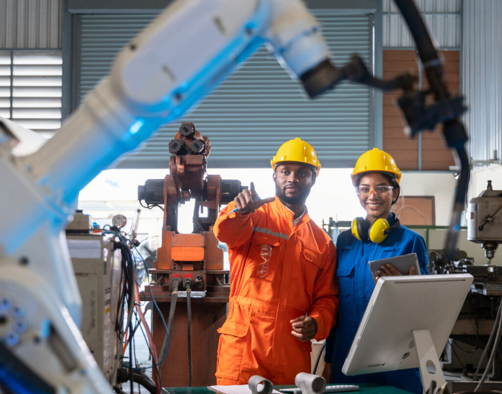 Team working with robots in factory.